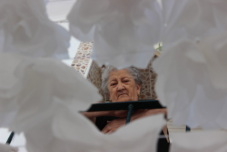 Under the paper flowers.