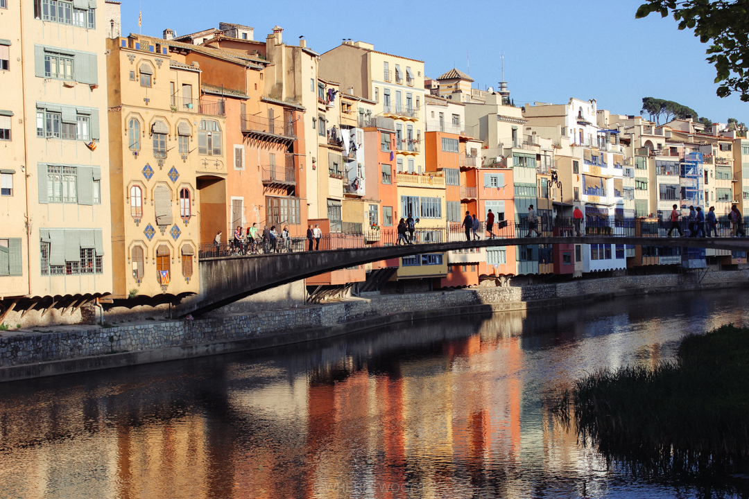 Colourful houses lining the Onyar river reflected in the water in Girona, Catalonia